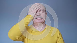 Senior hispanic adult man having terrible headache.