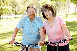 Senior Hispanic couple on bikes