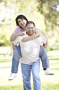 Senior Hispanic Couple Having Fun In Park