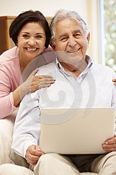 Senior Hispanic couple with laptop