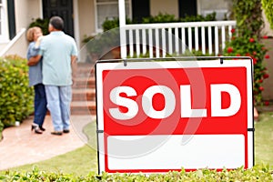 Senior Hispanic couple moving into new home