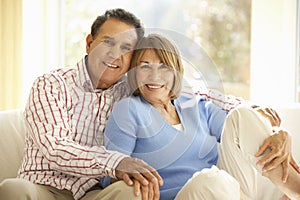 Senior Hispanic Couple Relaxing At Home