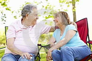 Senior Hispanic Couple Relaxing In Park