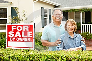 Senior Hispanic couple selling house photo