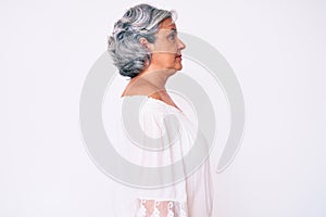 Senior hispanic grey- haired woman wearing casual clothes looking to side, relax profile pose with natural face with confident