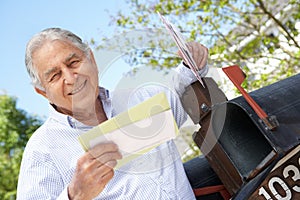 Senior Hispanic Man Checking Mailbox