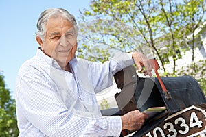 Senior Hispanic Man Checking Mailbox