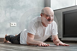 Senior hispanic man doing variation of cobra pose