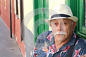 Senior Hispanic man looking at camera with incredulity