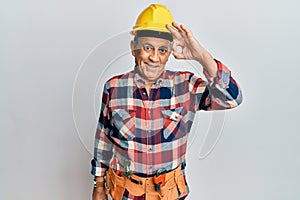 Senior hispanic man wearing handyman uniform smiling positive doing ok sign with hand and fingers