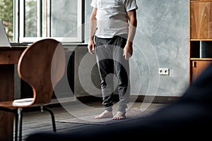 Senior hispanic man working out, standing on yoga mat