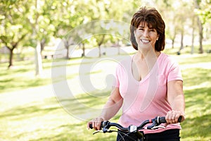 Senior Hispanic woman with bike