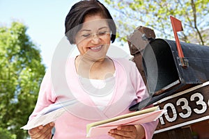 Senior Hispanic Woman Checking Mailbox