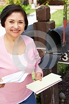 Senior Hispanic Woman Checking Mailbox