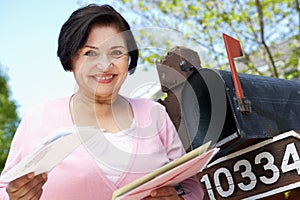 Senior Hispanic Woman Checking Mailbox