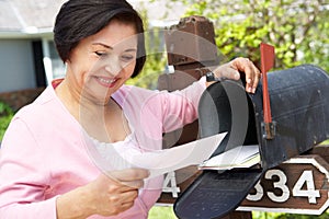 Senior Hispanic Woman Checking Mailbox