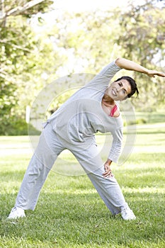 Senior Hispanic Woman Exercising In Park