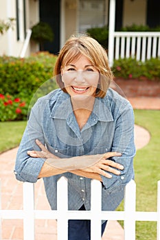 Senior Hispanic woman outside home photo