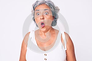 Senior hispanic woman wearing casual clothes scared and amazed with open mouth for surprise, disbelief face