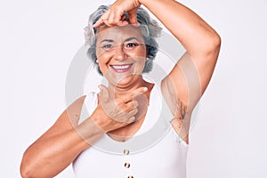 Senior hispanic woman wearing casual clothes smiling making frame with hands and fingers with happy face