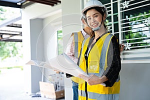 Senior home inspector checking home defects and teaching young engineers, before handing it over to client. Young engineers learn
