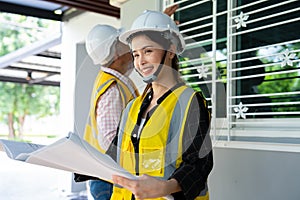 Senior home inspector checking home defects and teaching young engineers, before handing it over to client. Young engineers learn