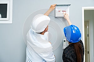 Senior home inspector checking home defects and teaching young engineers, before handing it over to client. Young engineers learn
