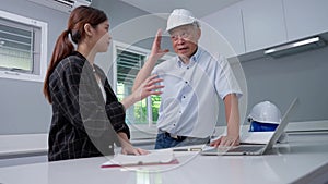 Senior home inspector checking home defects and teaching young engineers, before handing it over to client. Young engineers learn