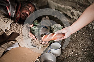 Senior homeless man and disabled with gray hair lying for help and food beggar because hungry from people on walking street