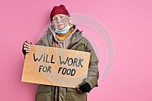 senior homeless woman is ready to work for food