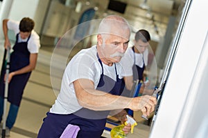 Senior housemaker with many cleaning supplies