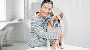 An senior hugging dog in smiling face, white background copy space