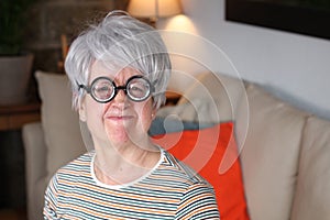 Senior humorous woman with old fashioned eyeglasses