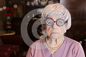 Senior humorous woman with old fashioned eyeglasses