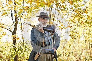 Senior hunter carry rifle gun on shoulder