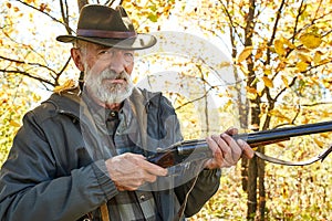 Senior hunter with gun ready to shoot his rifle