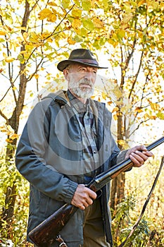 Senior hunter with gun ready to shoot his rifle