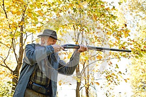 Senior hunter with gun ready to shoot his rifle