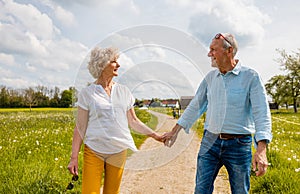 Senior husband and wife having a walk in the country