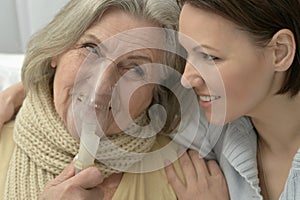 Senior ill woman with caring daughter