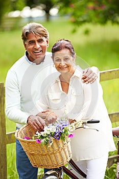 Senior Indian Couple On Cycle Ride In Countryside