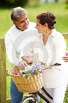 Senior Indian Couple On Cycle Ride In Countryside