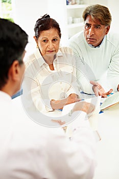 Senior Indian Couple Meeting With Financial Advisor At Home