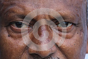 Senior Indian man`s eyes and wrinkles on skin close view.