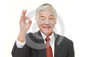 Senior Japanese businessman showing perfect sign