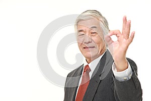 Senior Japanese businessman showing perfect sign