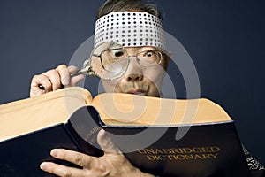 Senior japanese man examines dictionary