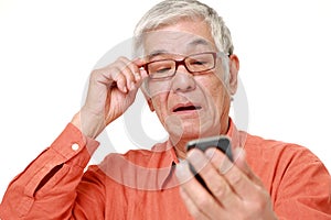 Senior Japanese man with presbyopia