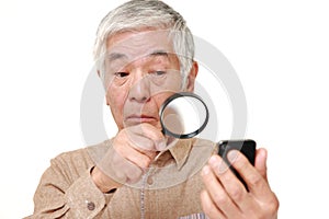 Senior Japanese man with presbyopia photo