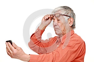 Senior Japanese man with presbyopia